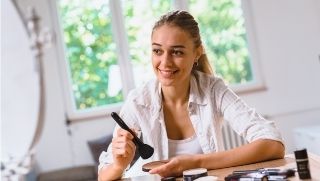 Woman applying make up